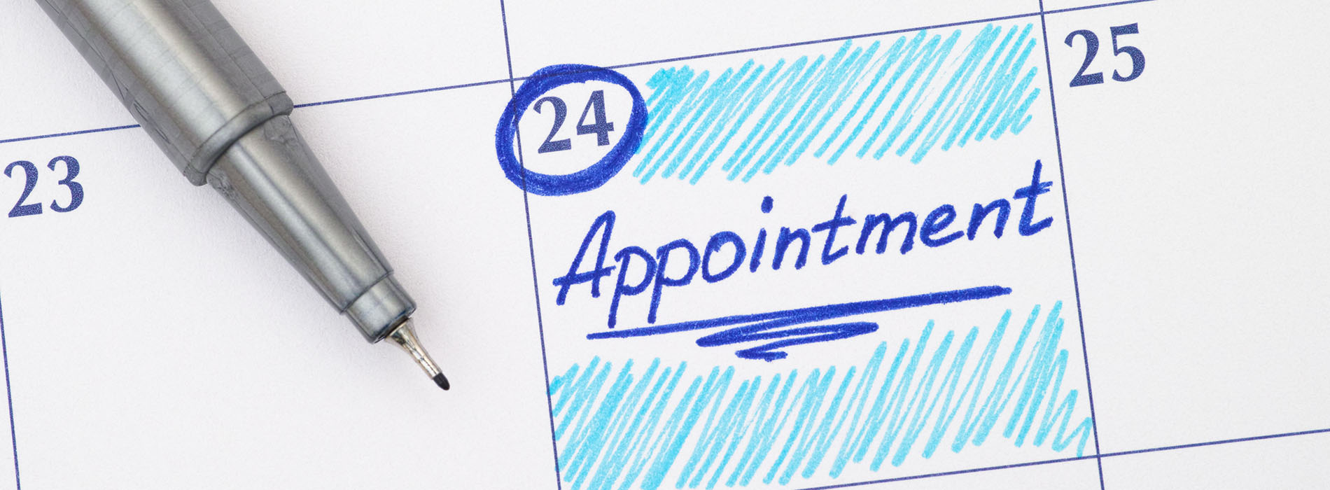 The image shows a close-up view of a pen resting on a calendar page with the word appointment written on it, indicating a scheduled event.